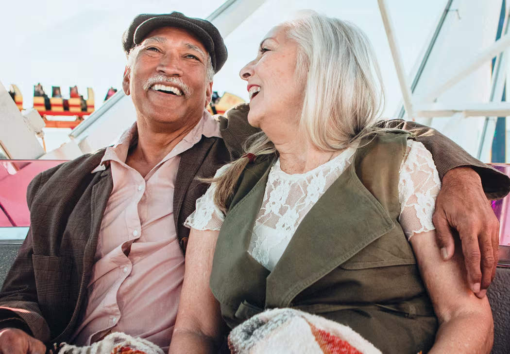Happy retired couple enjoying outdoor time together, representing financial freedom through passive income strategies in Canada
